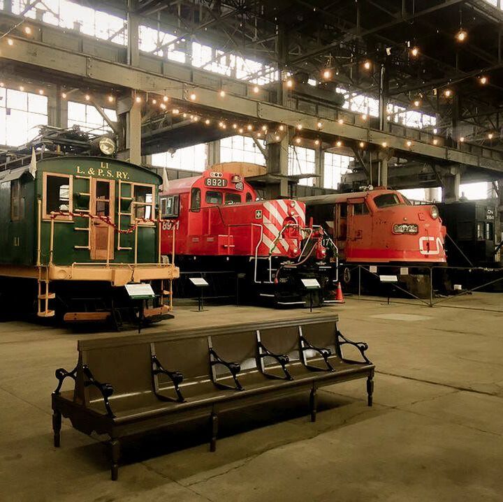 The Elgin County Railway Museum with three trail models. Above are stringed lights.